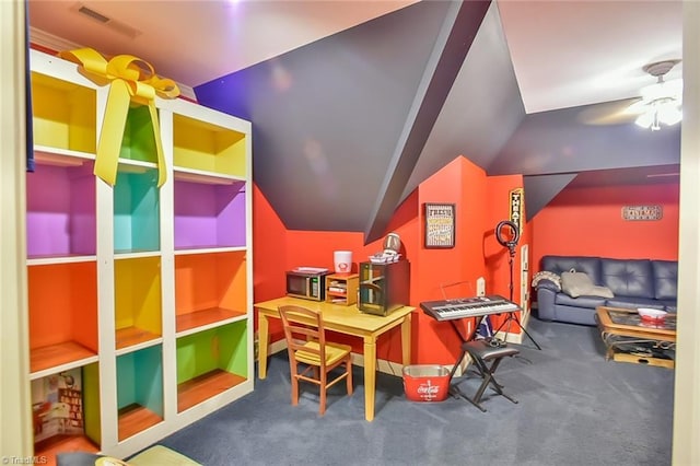 recreation room featuring ceiling fan, lofted ceiling, and dark colored carpet