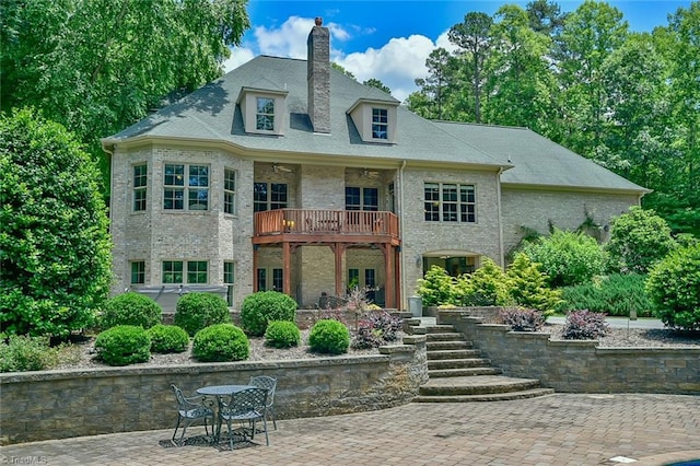 back of house with a balcony and a patio