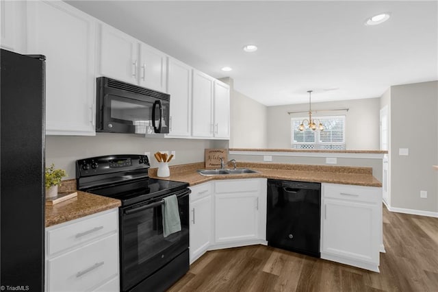 kitchen featuring dark wood-type flooring, sink, black appliances, kitchen peninsula, and white cabinets