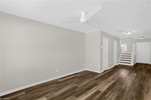 spare room featuring dark wood-type flooring and ceiling fan