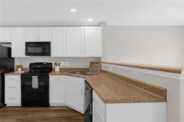 kitchen with sink, white cabinets, dark hardwood / wood-style flooring, and black appliances