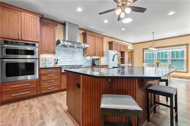 1420 Burnetts Chapel Rd, Greensboro, NC 27407 - kitchen featuring wall chimney range hood, appliances with stainless steel finishes, dark countertops, a sink, and tasteful backsplash