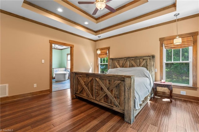 1420 Burnetts Chapel Rd, Greensboro, NC 27407 - bedroom with a tray ceiling, multiple windows, crown molding, wood finished floors, and baseboards