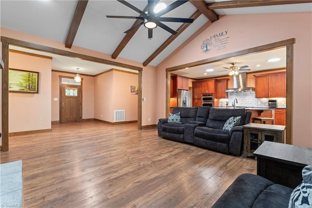 1420 Burnetts Chapel Rd, Greensboro, NC 27407 - living room featuring a ceiling fan, baseboards, beam ceiling, recessed lighting, and light wood-type flooring