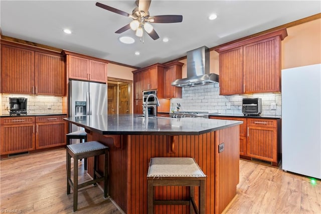 1420 Burnetts Chapel Rd, Greensboro, NC 27407 - kitchen with wall chimney range hood, appliances with stainless steel finishes, tasteful backsplash, a kitchen breakfast bar, and a ceiling fan