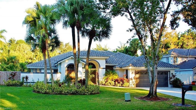 view of front of home with a garage and a front yard