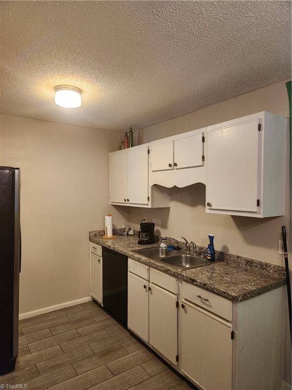 5517 Hornaday Rd Unit D, Greensboro, NC 27409 - kitchen with black appliances, a sink, white cabinetry, dark wood-style floors, and dark countertops
