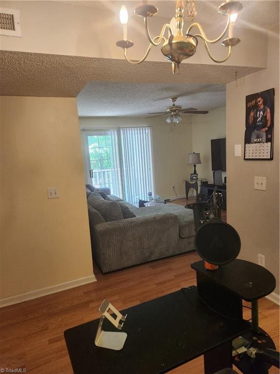 5517 Hornaday Rd Unit D, Greensboro, NC 27409 - living area with wood finished floors, baseboards, ceiling fan, a chandelier, and a textured ceiling