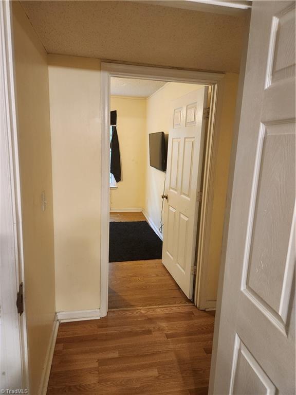 5517 Hornaday Rd Unit D, Greensboro, NC 27409 - corridor featuring wood finished floors and baseboards