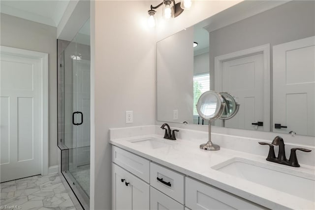 full bath featuring a shower stall, marble finish floor, double vanity, and a sink