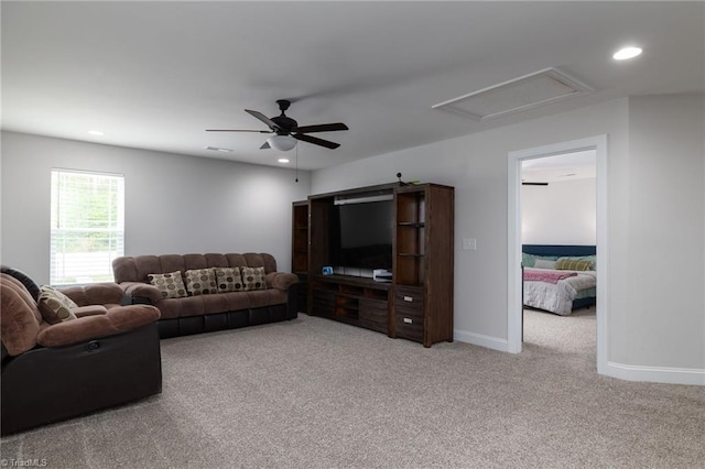 carpeted living area with attic access, recessed lighting, a ceiling fan, visible vents, and baseboards