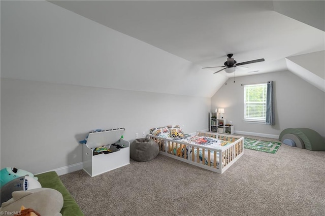 carpeted bedroom featuring ceiling fan, vaulted ceiling, and baseboards