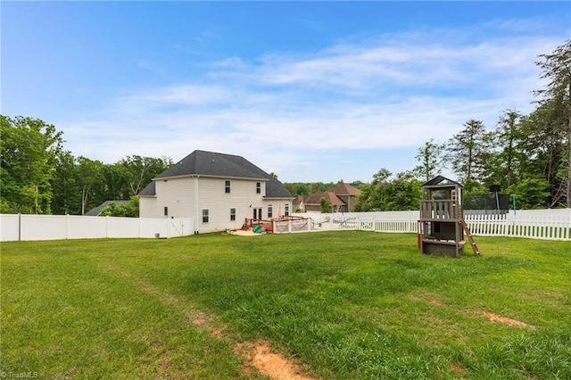 view of yard featuring a fenced backyard and a playground