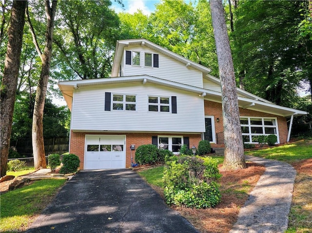 2841 Wesleyan Ln, Winston-Salem, NC 27106 - split level home with brick siding, asphalt driveway, and an attached garage