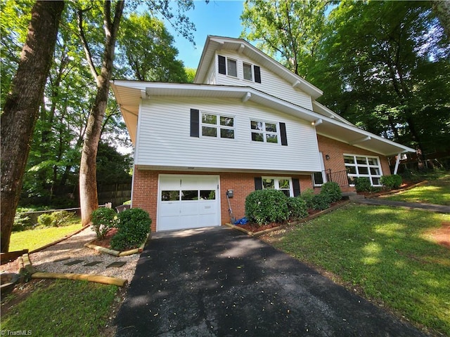 2841 Wesleyan Ln, Winston-Salem, NC 27106 - view of front facade with brick siding, driveway, a garage, and a front yard