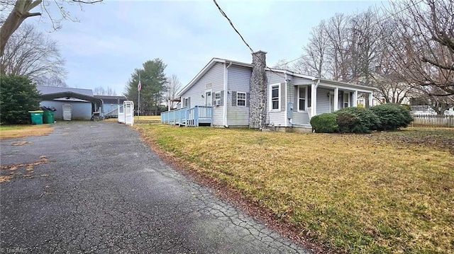 view of side of home with a lawn