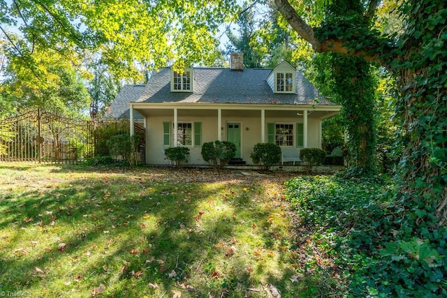 cape cod-style house with a porch and a front yard