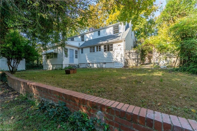 rear view of property with a lawn