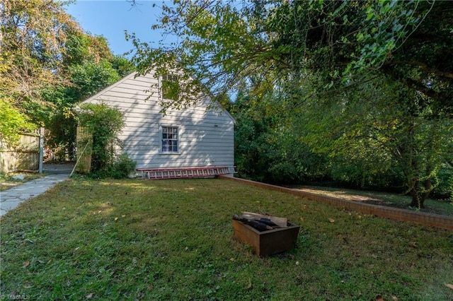 view of side of home with a yard