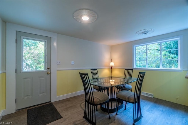 dining space with wood-type flooring