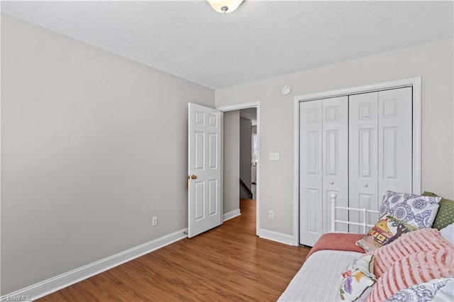 living area with hardwood / wood-style floors and a textured ceiling