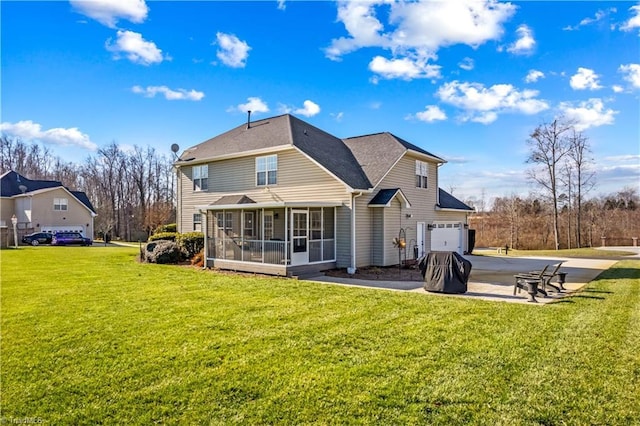 back of property featuring a sunroom, a garage, and a lawn