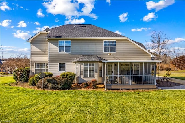 back of property with a sunroom and a lawn