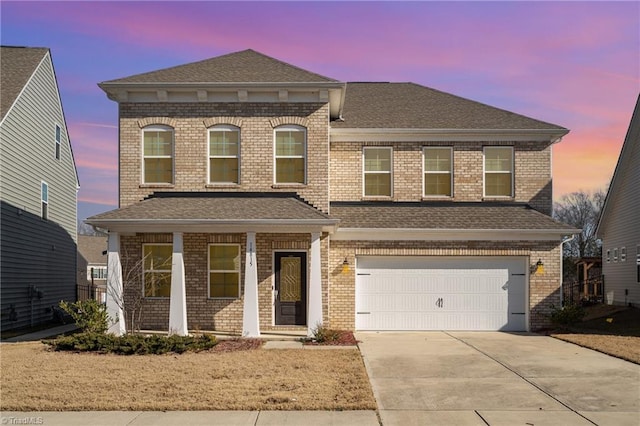 view of front facade featuring a garage and covered porch