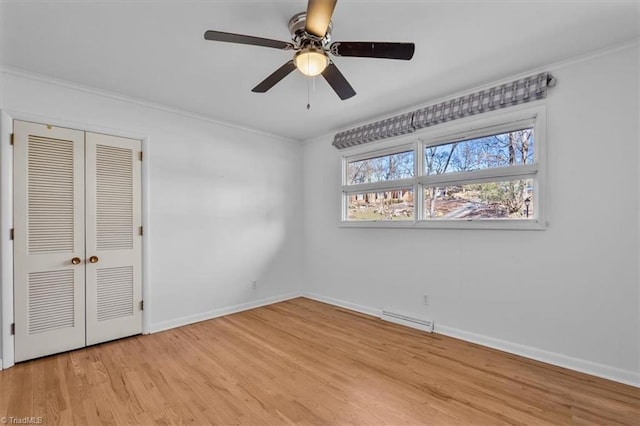 unfurnished bedroom featuring visible vents, ornamental molding, a closet, light wood-style floors, and baseboards