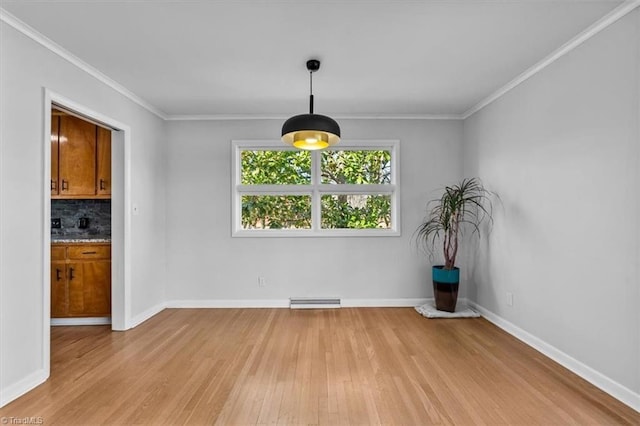 unfurnished dining area featuring light wood-type flooring, baseboards, visible vents, and crown molding