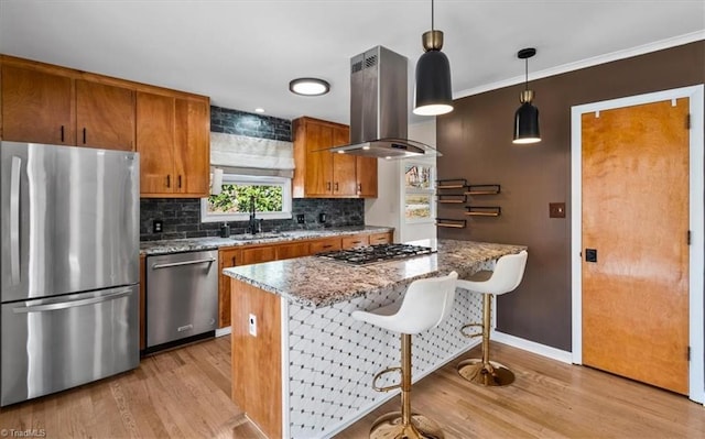 kitchen with backsplash, ventilation hood, appliances with stainless steel finishes, brown cabinetry, and light wood finished floors