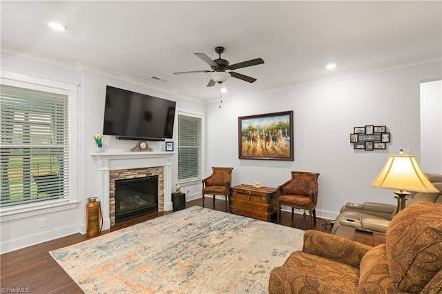 254 Kilbourne Dr, Advance, NC 27006 - living area with a ceiling fan, crown molding, dark wood-style floors, a stone fireplace, and recessed lighting