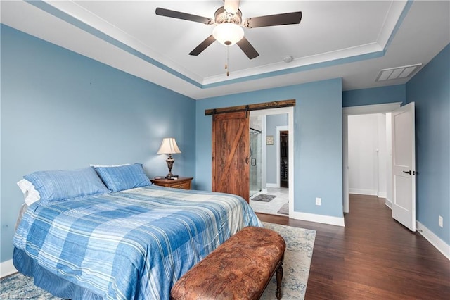 254 Kilbourne Dr, Advance, NC 27006 - bedroom featuring a raised ceiling, wood finished floors, a barn door, and a ceiling fan