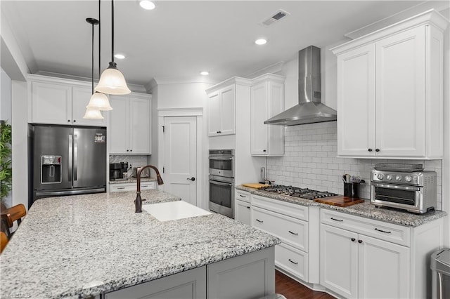 254 Kilbourne Dr, Advance, NC 27006 - kitchen featuring appliances with stainless steel finishes, wall chimney range hood, white cabinetry, decorative backsplash, and recessed lighting