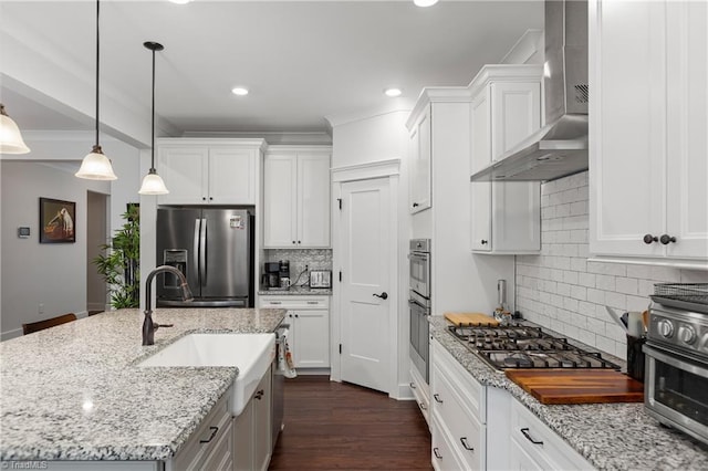 254 Kilbourne Dr, Advance, NC 27006 - kitchen featuring appliances with stainless steel finishes, wall chimney exhaust hood, white cabinetry, decorative backsplash, and recessed lighting