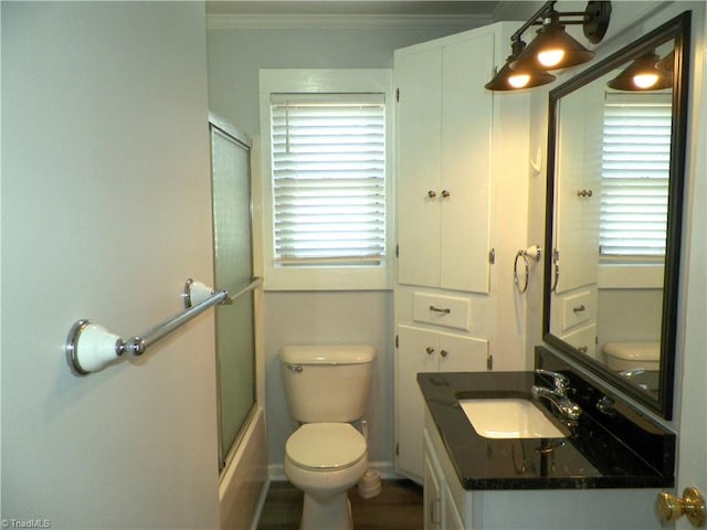 bathroom with ornamental molding, vanity, toilet, and baseboards