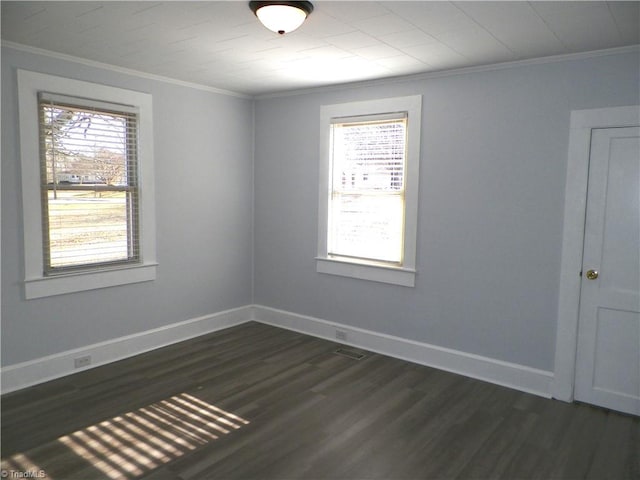 unfurnished room with baseboards, ornamental molding, dark wood-type flooring, and a healthy amount of sunlight