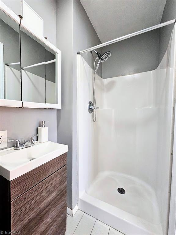 bathroom featuring vanity and walk in shower