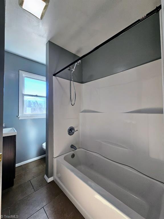 full bathroom featuring vanity, toilet, tile patterned floors, and shower / bathing tub combination