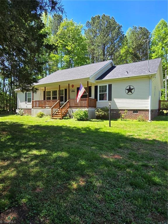 view of front facade featuring crawl space, roof with shingles, covered porch, and a front yard