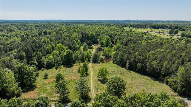 drone / aerial view featuring a forest view