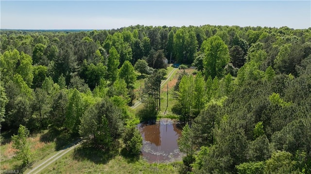 birds eye view of property featuring a water view and a forest view