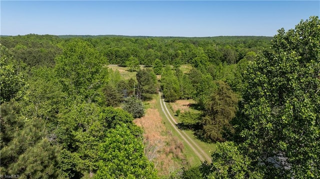aerial view featuring a wooded view