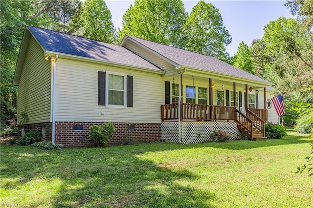ranch-style home featuring roof with shingles, covered porch, a front yard, and crawl space