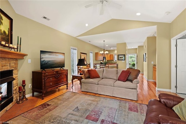 196 Evergreen Springs Ct Unit 602, Blowing Rock, NC 28605 - living area with a stone fireplace, a chandelier, vaulted ceiling, ceiling fan, and baseboards
