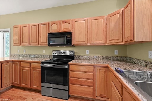 196 Evergreen Springs Ct Unit 602, Blowing Rock, NC 28605 - kitchen with black microwave, electric stove, light wood finished floors, light countertops, and a sink