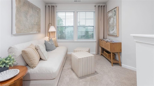 sitting room featuring light colored carpet