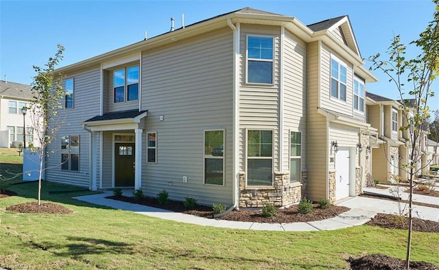 view of front of home featuring a garage and a front lawn