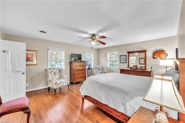 bedroom with ceiling fan and light hardwood / wood-style floors