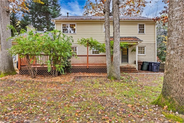 back of house with a wooden deck